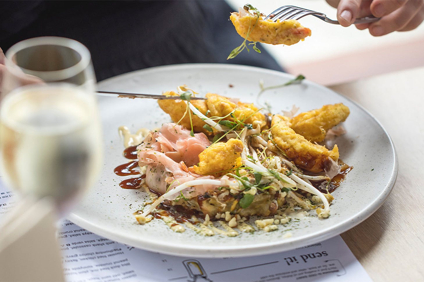 Someone tucks into hearty fare at odd saint, one of the best cafes in Queenstown.